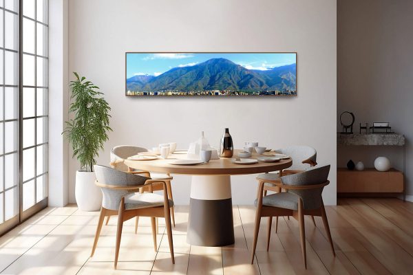 Guardian Ávila panoramic fine art canvas print displayed above a wooden dining table in a modern dining room with large windows and natural light.